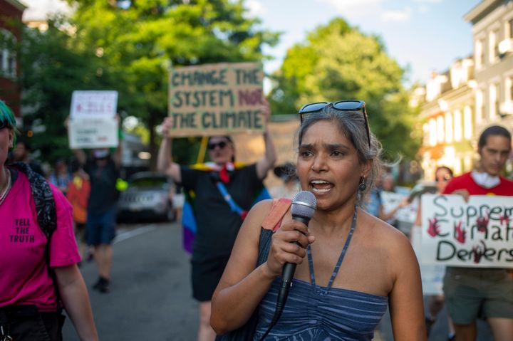 Members of Extinction Rebellion DC, ShutDown DC and Arm in Arm DC participate in a "Tour of Shame", marching to the homes of senators they consider most responsible for a reduction in climate change regulations on June 30, 2022 in Washington, DC.
