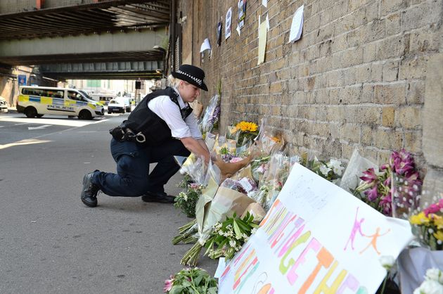 A police officer laying flowers close to Finsbury Park Mosque in north London, where Makram Ali, 51, died when Darren Osborne ploughed a hired van into worshippers gathered outside. 
