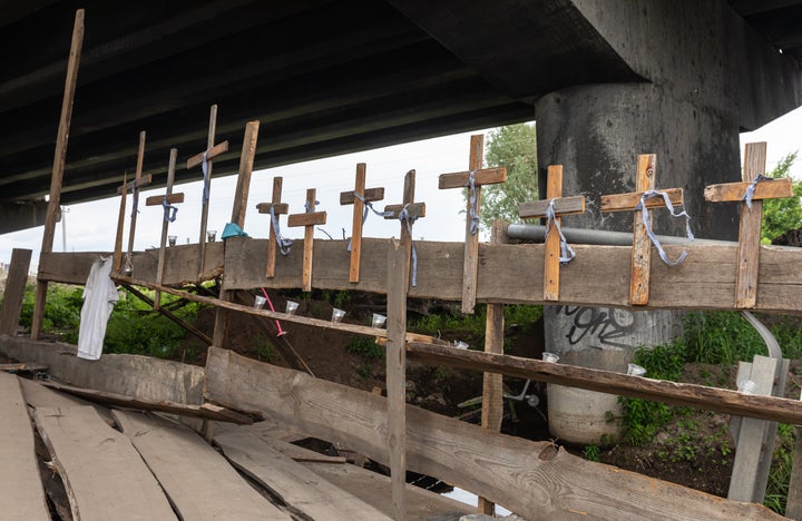 Crosses attached to a destroyed bridge in the town of Irpin, in the Kyiv region of Ukraine, memorialize the 60 people killed in nearby Bucha by Russian forces. Whether Russia's actions in the invasion of Ukraine rise to the level of genocide, as defined in a 1948 global treaty, has come under debate.