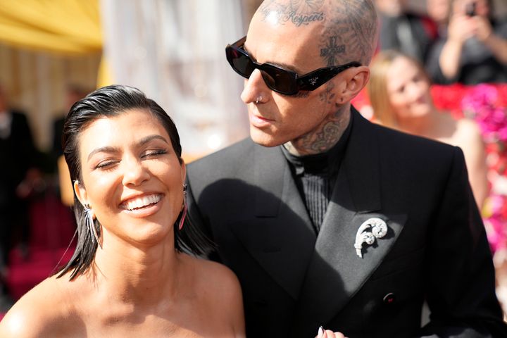 Kourtney Kardashian (left,) and Travis Barker at the Oscars in May.
