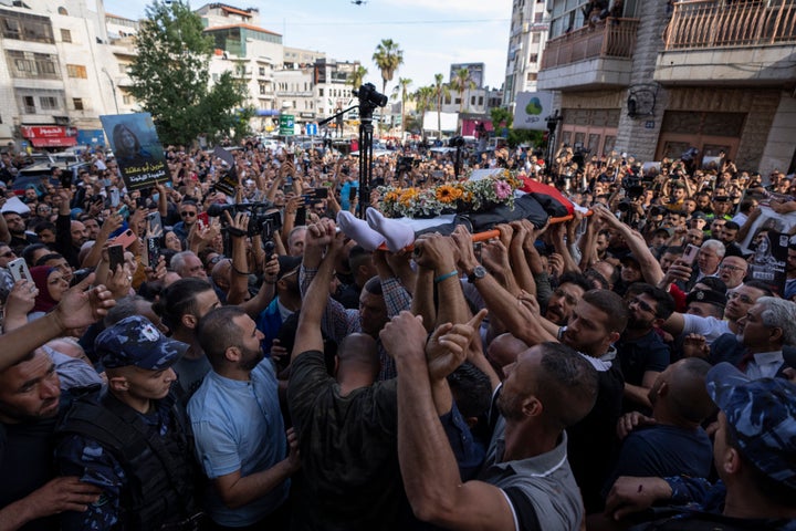 Palestinian mourners carry the body of veteran Al Jazeera journalist Shireen Abu Akleh toward the Al Jazeera office for her fellow journalists to pay their respects, in the West Bank city of Ramallah, Wednesday, May 11, 2022. Abu Akleh, 51, was shot and killed while covering an Israeli military raid in the occupied West Bank town of Jenin early Wednesday. The broadcaster and a reporter who was wounded in the incident blamed Israeli forces. (AP Photo/Nasser Nasser)