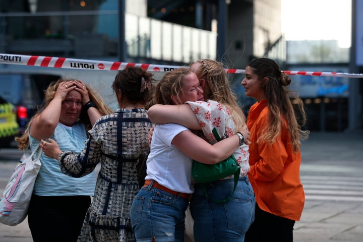 Peope react outside Field's shopping center in Copenhagen, Denmark, Sunday July 3, 2022. Danish police say several people have been shot at a Copenhagen shopping mall. Copenhagen police said that one person has been arrested in connection with the shooting at the Field’s shopping mall on Sunday. Police tweeted that “several people have been hit” but gave no other details. (Olafur Steinar Gestsson/Ritzau Scanpix via AP)
