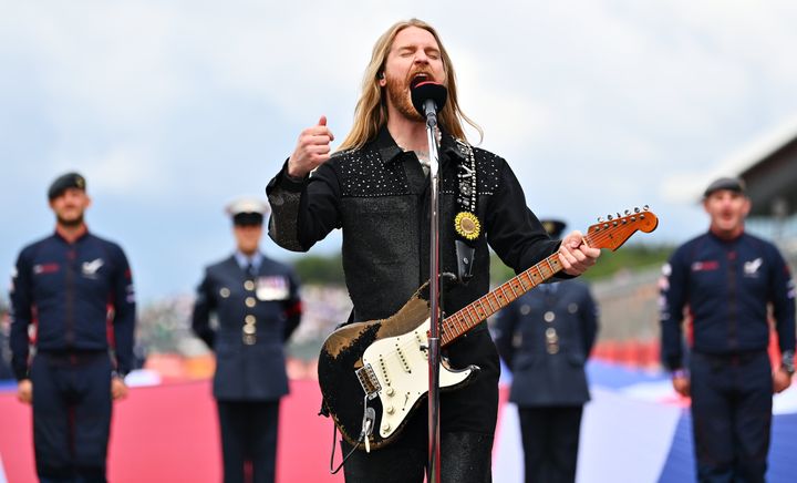 Musician Sam Ryder performs the British national anthem on the grid before the F1 Grand Prix of Great Britain on July 3 in Northampton, England. 
