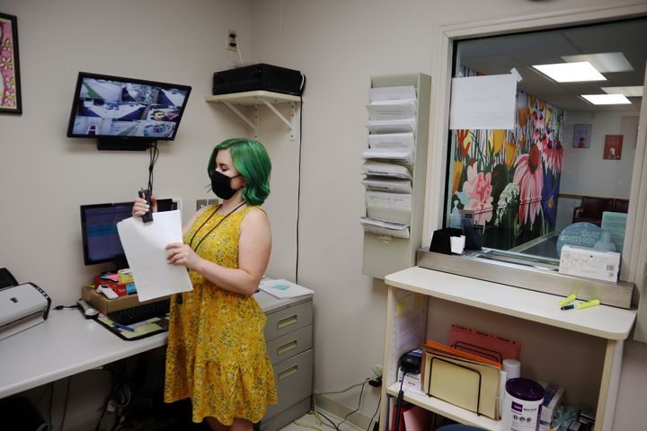 Beth Fiddler, a receptionist and telephone consultant at the Women's Health Center of West Virginia, staples paperwork in her office outside the clinic's empty waiting room on June 29, 2022 in Charleston, W.Va. 