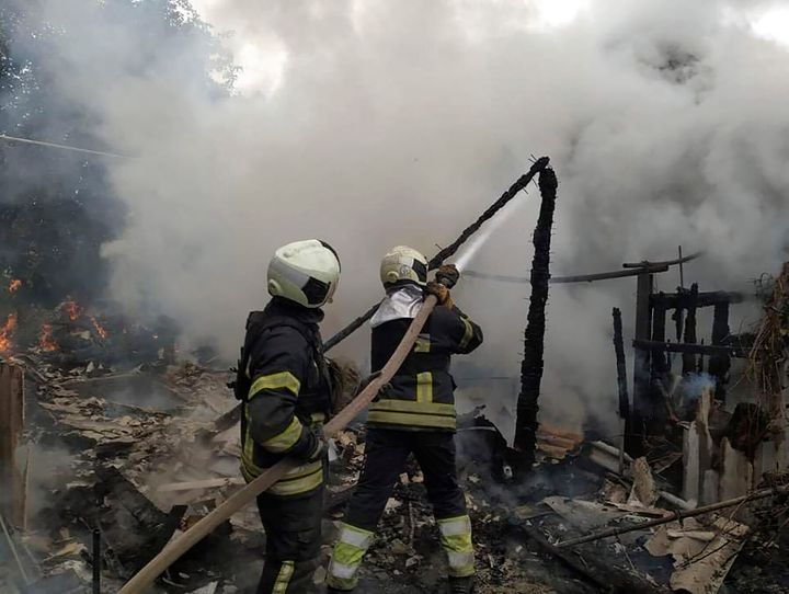 In this photo provided by the Luhansk region military administration, Ukrainian firefighters work to extinguish a fire at damaged residential building in Lysychansk, Luhansk region, Ukraine, early Sunday, July 3, 2022.