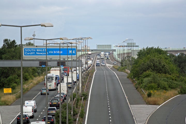 Police escort vehicles across the Prince of Wales Bridge, which runs between England and Wales, during the morning rush hour as drivers hold a go-slow protest on the M4.