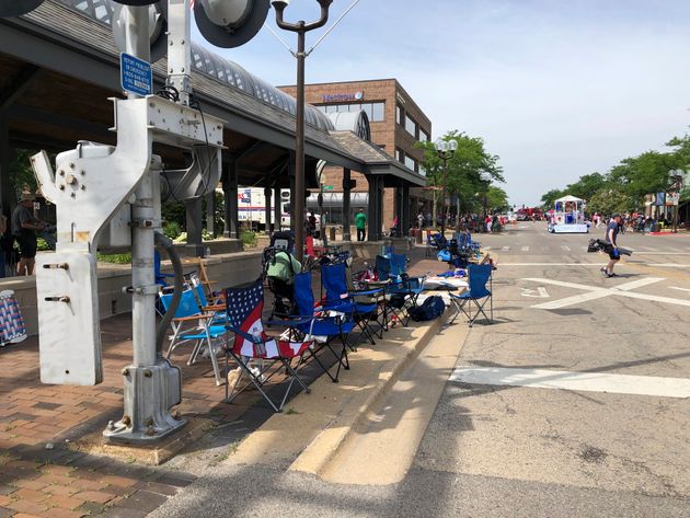 Empty chairs sit along the sidewalk after parade-goers fled Highland Park's Fourth of July parade after shots were fired, Monday, July 4, 2022 in Chicago. (Lynn Sweet/Chicago Sun-Times via AP)