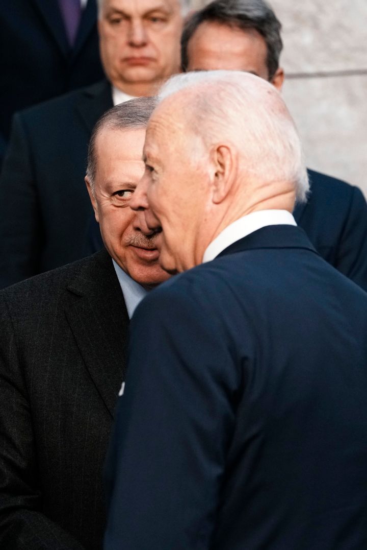 U.S. President Joe Biden, front right, speaks with Turkish President Recep Tayyip Erdogan, front left, at a group photo during an extraordinary NATO summit at NATO headquarters in Brussels, Thursday, March 24, 2022. As the war in Ukraine grinds into a second month, President Joe Biden and Western allies are gathering to chart a path to ramp up pressure on Russian President Vladimir Putin while tending to the economic and security fallout that's spreading across Europe and the world. (AP Photo/Thibault Camus)