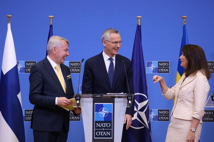 Finnish Foreign Minister Pekka Haavisto (L) shares a laugh with Swedish Ministry for Foreign Affairs Ann Linde (R) and NATO Secretary General Jens Stoltenberg (C) following a press conference at the NATO headquarters in Brussels on July 5, 2022.