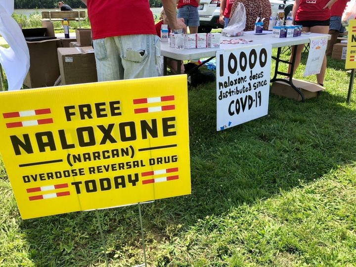 Signs are displayed at a tent during a health event on June 26, 2021, in Charleston, W.Va. A federal judge on July 4, 2022, ruled in favor of three major U.S. drug distributors in a landmark lawsuit that accused them of causing a health crisis in one West Virginia county ravaged by opioid addiction.