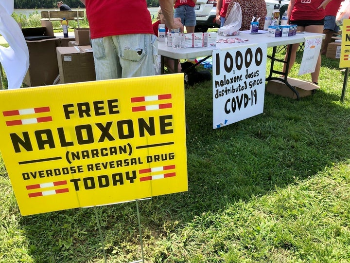 Signs are displayed at a tent during a health event on June 26, 2021, in Charleston, W.Va. A federal judge on July 4, 2022, ruled in favor of three major U.S. drug distributors in a landmark lawsuit that accused them of causing a health crisis in one West Virginia county ravaged by opioid addiction.