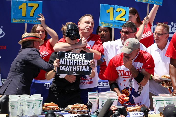 Joey Chestnut applies a chokehold on a protester who interrupted the Nathan's Hot Dog Eating Contest.