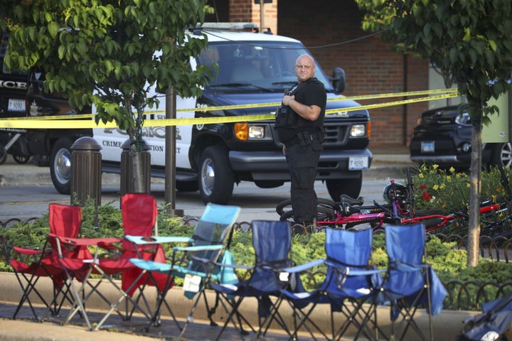 Police officers patrol Central Avenue on Tuesday, July 5, 2022 following a mass shooting in Highland Park, Illinois.