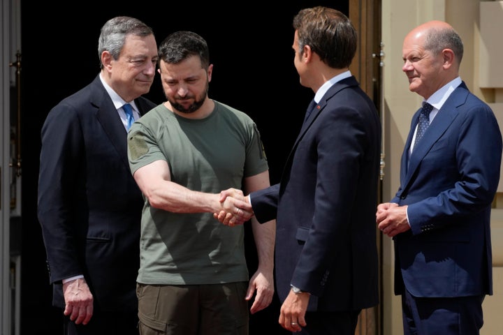 FILE - Ukrainian President Volodymyr Zelenskyy, second left, shake hands with French President Emmanuel Macron, as they are flanked by Italian Prime Minister Mario Draghi, left, and German Chancellor Olaf Scholz, at the Mariyinsky Palace in Kyiv, Ukraine, June 16, 2022. The European leaders saw the ruins of a Kyiv suburb and denounced the brutality of a Russian invasion that has killed many civilians. Ukraine is already effectively using heavy howitzers and advanced rocket systems sent by the U.S. and other Western allies, and more is on the way. (AP Photo/Natacha Pisarenko, File)