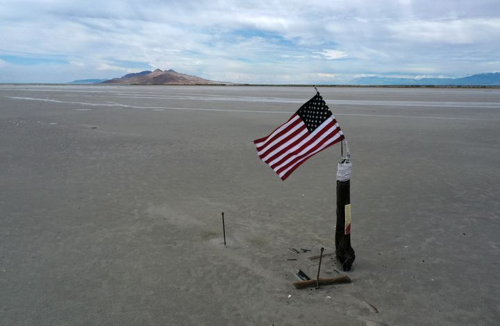 An American flag waves over a part of the Great Salt Lake that used to be underwater.