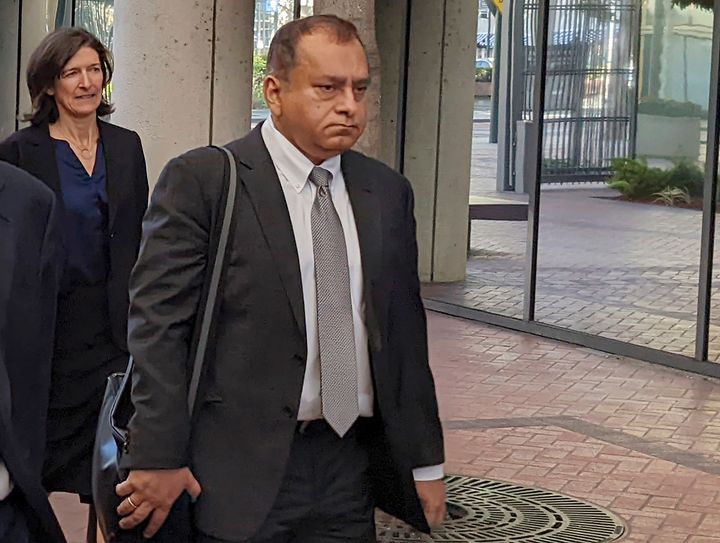 Ramesh "Sunny" Balwani, right, the former lover and business partner of Theranos CEO Elizabeth Holmes, walks into federal court in San Jose, Calif., Friday, June 24, 2022. Balwani was found guilty in Theranos blood-testing fraud case, Thursday, July 7. (AP Photo/Michael Liedtke, File)