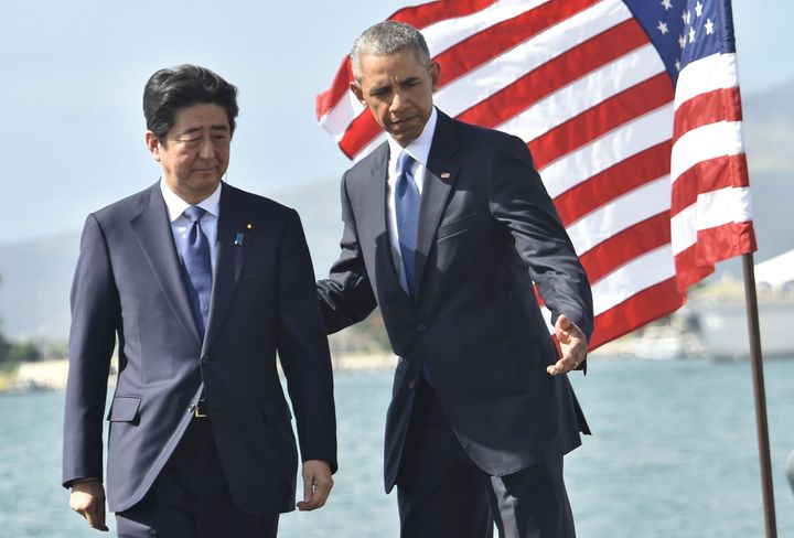 U.S. President Barack Obama speaks with Abe on Dec. 27, 2016, at Pearl Harbor in Honolulu.
