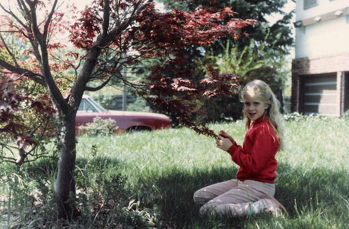 The author, age 9, in the family's front yard, in a photo taken by her father.