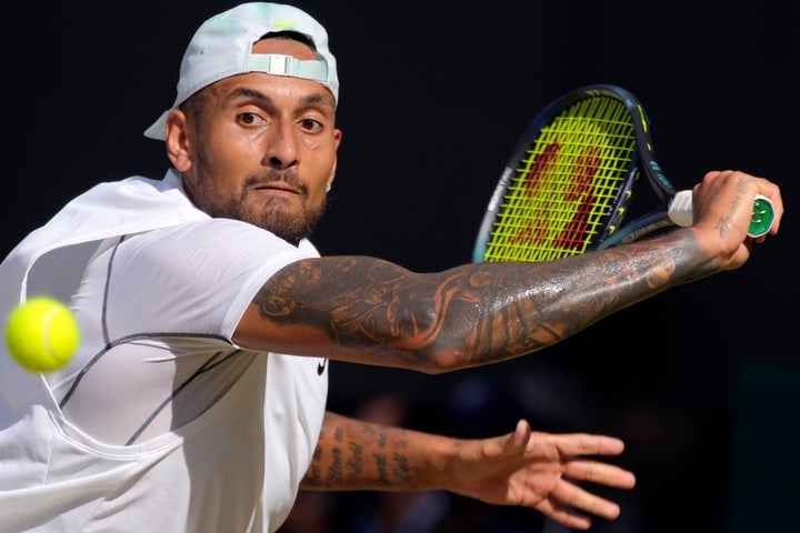 Australia's Nick Kyrgios returns to Serbia's Novak Djokovic during the final of the men's singles on day fourteen of the Wimbledon tennis championships in London, Sunday, July 10, 2022. (AP Photo/Kirsty Wigglesworth)