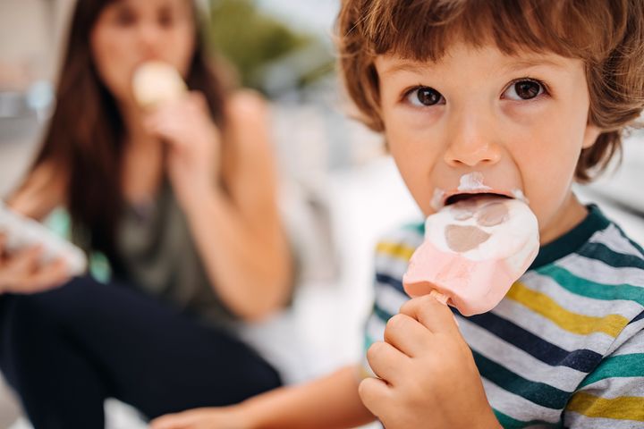 Close-up kid eating ice cream in summer