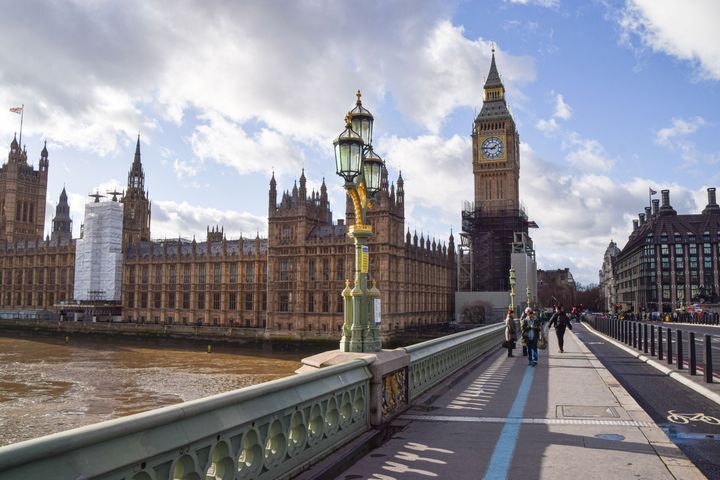 General view of Westminster Bridge, Houses of Parliament, and Big Ben on a sunny day.