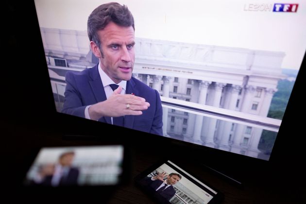 A picture taken in Paris on June 16, 2022, shows TV screens displaying a live televised interview by a French television channel of French President Emmanuel Macron, during his official visit to the Ukraine. - The European Union's most powerful leaders on June 16, 2022, embraced Ukraine's bid to be accepted as a candidate for EU membership, in a powerful symbol of support in Kyiv's battle against Russia's invasion. French President Emmanuel Macron, Germany's Chancellor Olaf Scholz and Italian premier Mario Draghi arrived in Ukraine by train and headed to the Kyiv suburb of Irpin, scene of fierce battles early in the brutal war. (Photo by Thomas SAMSON / AFP) (Photo by THOMAS SAMSON/AFP via Getty Images)