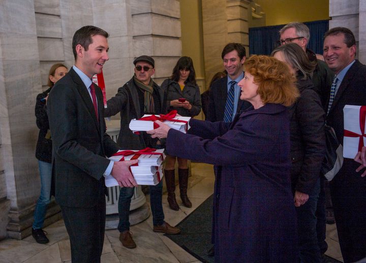 Simon, center right, hands over a stack of signed petitions to the office of then-New York City Mayor Bill de Blasio in 2015. She has a history of opposing new real estate developments.