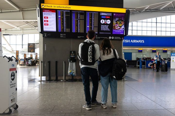 Dos pasajeros observan la información de sus vuelos en el aeropuerto de Heathrow (Londres, Reino Unido), a finales de junio.