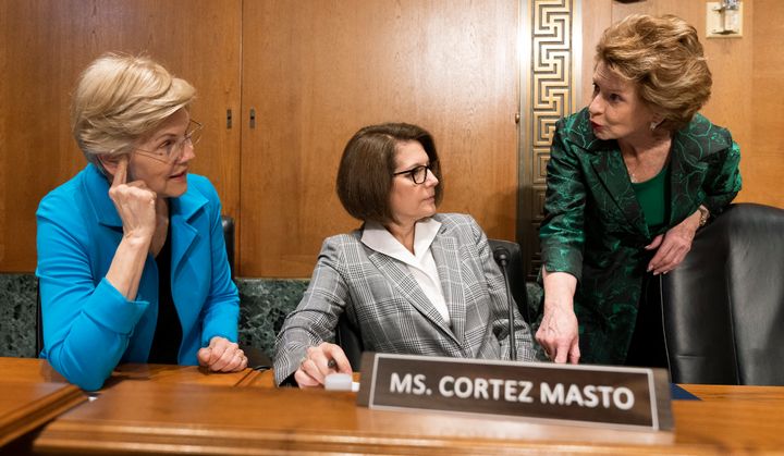 From left, Sen. Elizabeth Warren (D-Mass.), Sen. Catherine Cortez Masto (D-Nev.), and Sen. Debbie Stabenow (D-Mich.), talk before the start of a Senate Finance Committee hearing to examine President Joe Biden's proposed budget request for fiscal year 2023, on June 7, 2022.
