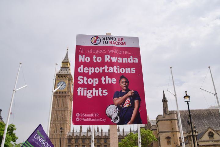 A placard opposing the deportation of refugees to Rwanda is seen during the demonstration in Parliament Square. 