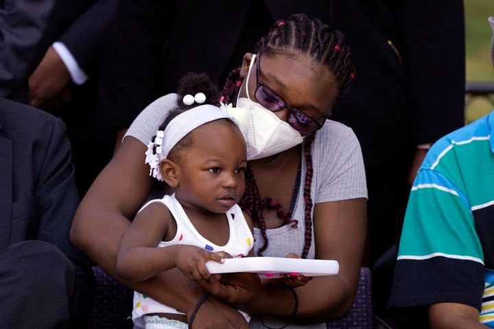 Starmanie Jackson holds her child, Gabriella, during a news conference Tuesday, July 12, 2022, in Detroit. At the time of her incarceration in April 2019, Jackson, an impoverished single mother of 2- and 4-year-old children, had her bail set at $700 over outstanding traffic tickets and a charge alleging domestic violence. Because she could not afford to pay, Jackson, who had never been arrested before, was separated from her children for the first time in their lives. Michigan's largest district court and bail reform advocates announced the settlement of a class-action lawsuit against bail practices in Detroit. (AP Photo/Carlos Osorio)