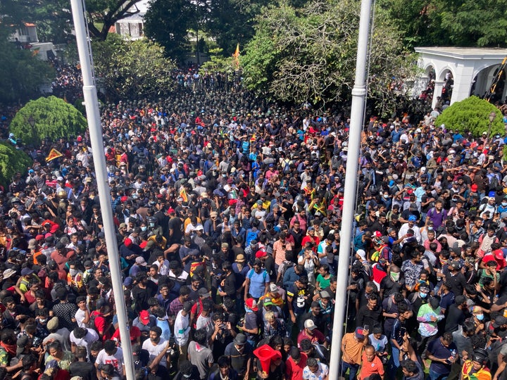 Sri Lankan protesters storm the compound of prime minister Ranil Wickremesinghe's office, demanding he resign after president Gotabaya Rajapaksa fled the country amid economic crisis in Colombo, Sri Lanka, on July 13, 2022. 