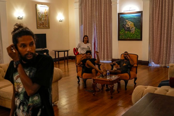 Protesters sit on sofas inside the official residence of president Gotabaya Rajapaksa four days after it was stormed by anti government protesters in Colombo in Colombo, Sri Lanka, on July 13, 2022.