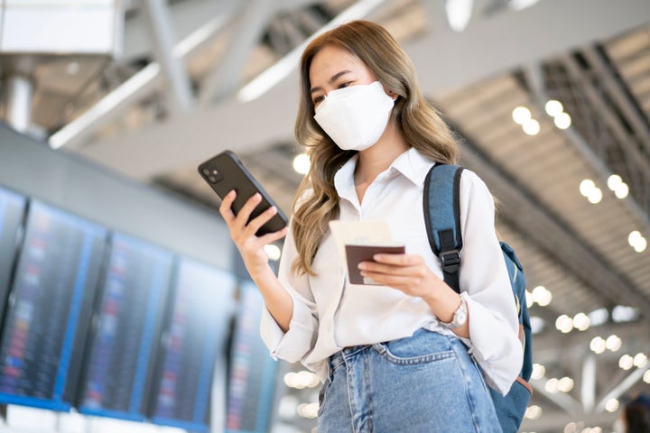 Traveler holds vaccine passport certificate to show COVID 19 vaccination status