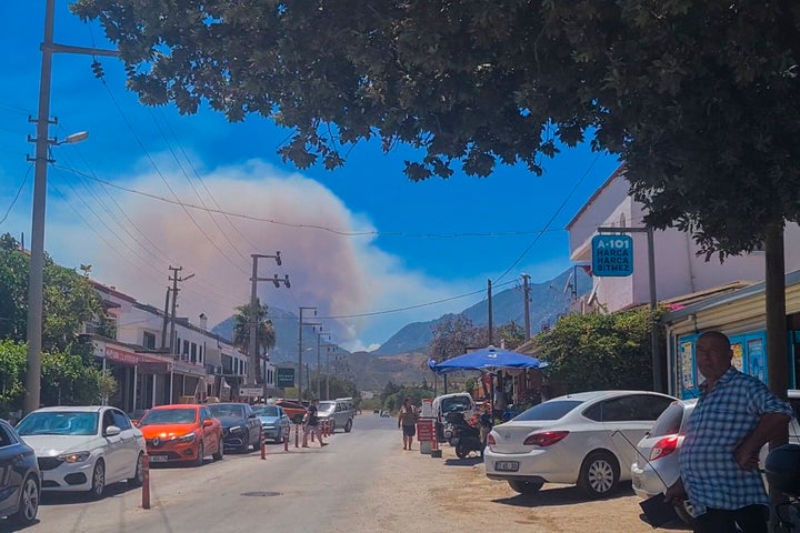 In this image from video, smoke rises from a wildfire in the mountains close to Mesudiye village, Turkey, Wednesday, July 13, 2022.