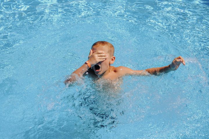 the child is drowning in the pool. drowning man. dangerous swimming. save a person. High quality photo