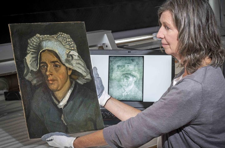 Senior Conservator Lesley Stevenson views "Head of a Peasant Woman" alongside an x ray image of the hidden Van Gogh self portrait. 