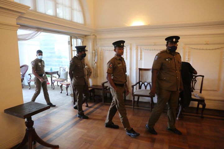 Sri Lankan police enter the Prime Minister's official residence as protesters leave the Prime Minister's official residence during the handover of the building in Colombo, Sri Lanka on July 14, 2022. Amid protests against his government, Sri Lankan President Gotabaya Rajapaksa fled from Sri Lanka to the Maldives on Wednesday and arrived at Singapore's Changi Airport today (14). He has not submitted his resignation letter yet.(Photo by Pradeep Dambarage/NurPhoto via Getty Images)