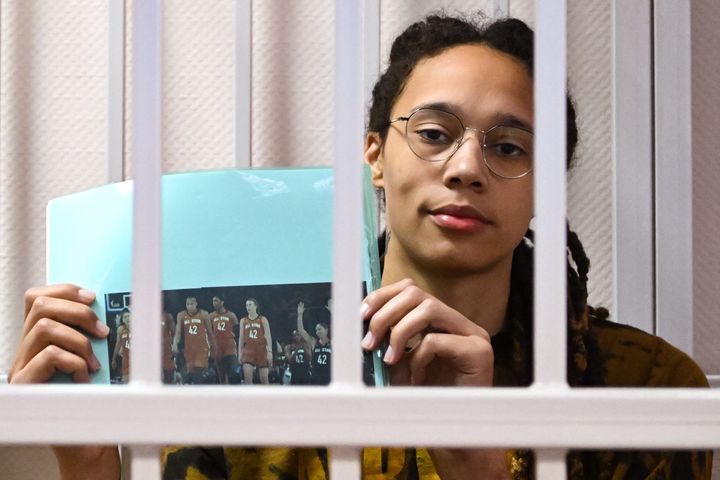 Brittney Griner sits inside a defendants' cage with a picture depicting her WNBA fellow players wearing jerseys with her number, 42, during the leagues All-Star Game, during a hearing at the Khimki Court in the town of Khimki outside Moscow on July 15, 2022.