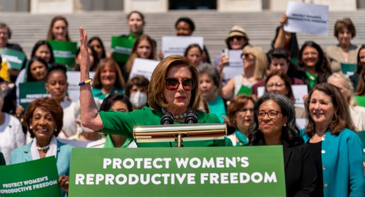 House Speaker Nancy Pelosi (D-Calif.) and other Democrats wore green on Friday in support of abortion rights. 