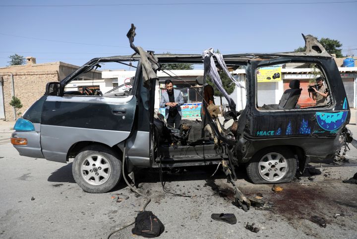 Afghan journalists film the site of a bomb explosion in Kabul, June 3, 2021. No one took responsibility for the attack, which took place in a neighborhood largely populated by the minority Hazara ethnic group.