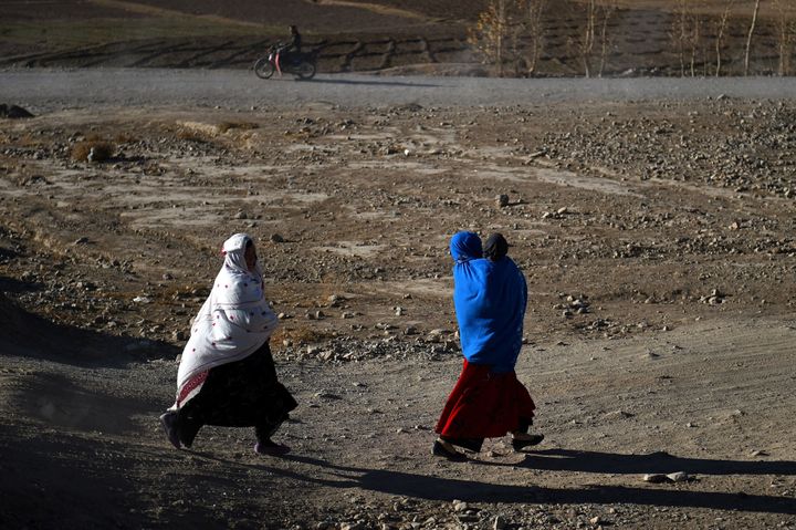 Hazara women walk along a road in Afghanistan's Bamiyan Province, Nov. 6, 2016.
