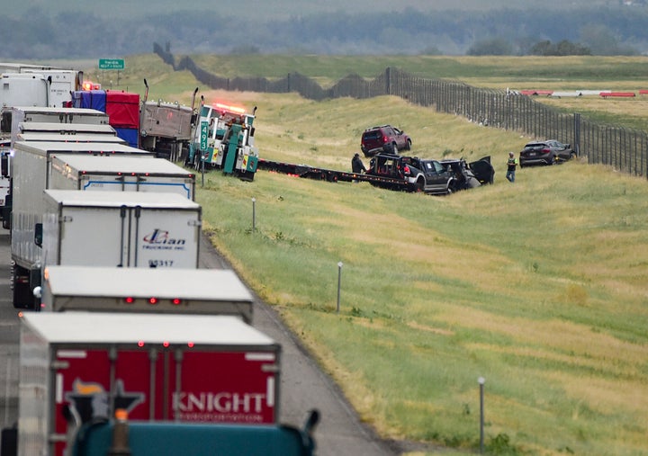 First responders work the scene on Interstate 90 after a fatal pileup where at least 20 vehicles crashed near Hardin, Montana.