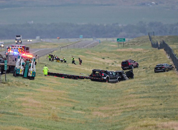 First responders work the scene on Interstate 90 after a fatal pileup where at least 20 vehicles crashed near Hardin, Montana.