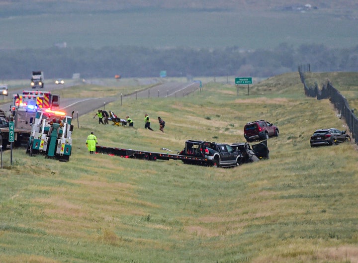 First responders work the scene on Interstate 90 after a fatal pileup where at least 20 vehicles crashed near Hardin, Montana.