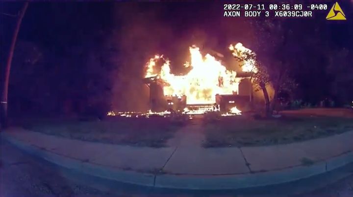 An image of the burning home just before Nicholas Bostic raced out carrying a 6-year-old girl.