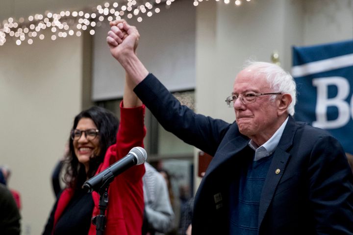 Rep. Rashida Tlaib (left) campaigns for the presidential campaign of Sen. Bernie Sanders (right) in Iowa in January 2020. The lawmakers are part of a newer faction of pro-Palestinian progressives.