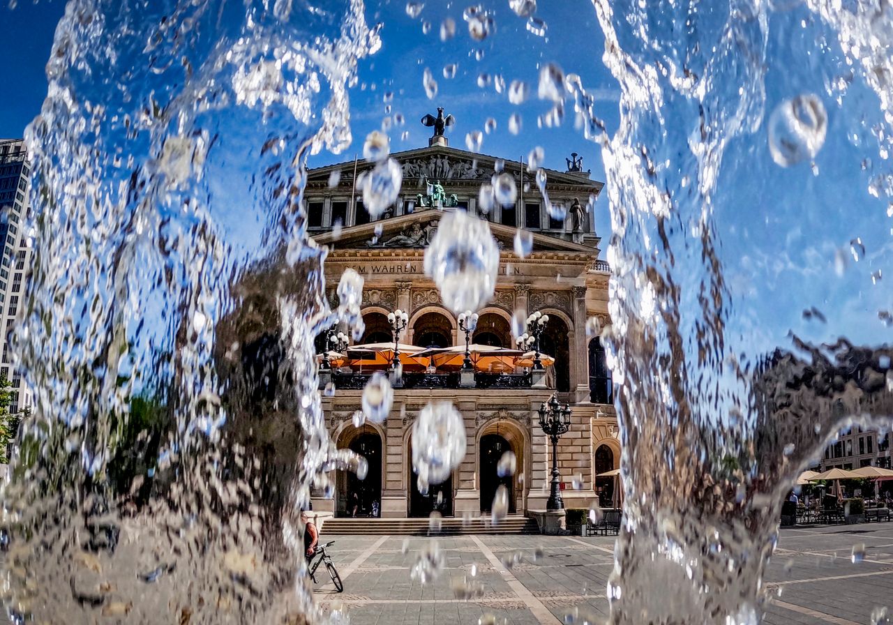 Water from a fountain runs down in front of the Old Opera in Frankfurt, Germany, on Monday. Germany expects high temperatures on Monday and Tuesday.