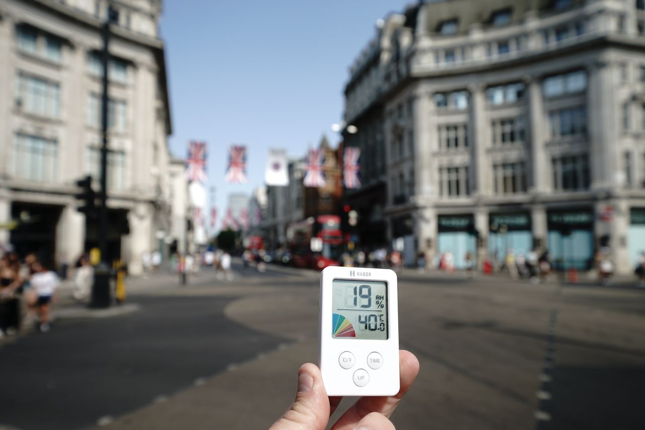A digital thermometer displays a temperature of 40 degrees Celsius (approximately 104 degrees Fahrenheit) in Oxford Circus, central London.