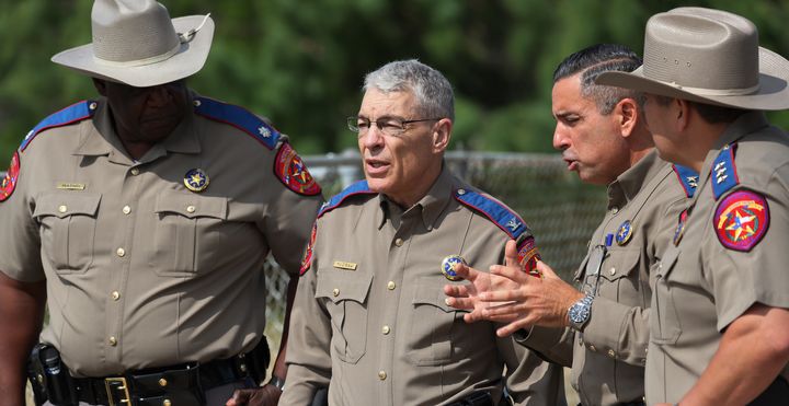 Col. Steven c. Mccraw, director of the texas department of public safety (center), speaks with texas state police near robb elementary school on may 30.